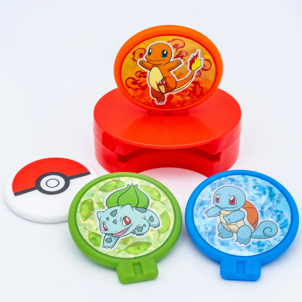 Close up of the holographic Pokémon Panels for Charmander, Bulbasaur and Squirtle, showing the shifting foil pattern behind each character
