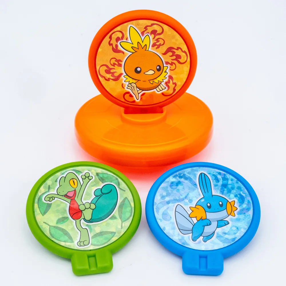 The Hoenn spinner with its three panels laid beside it, showing how any of them can be swapped into the base
