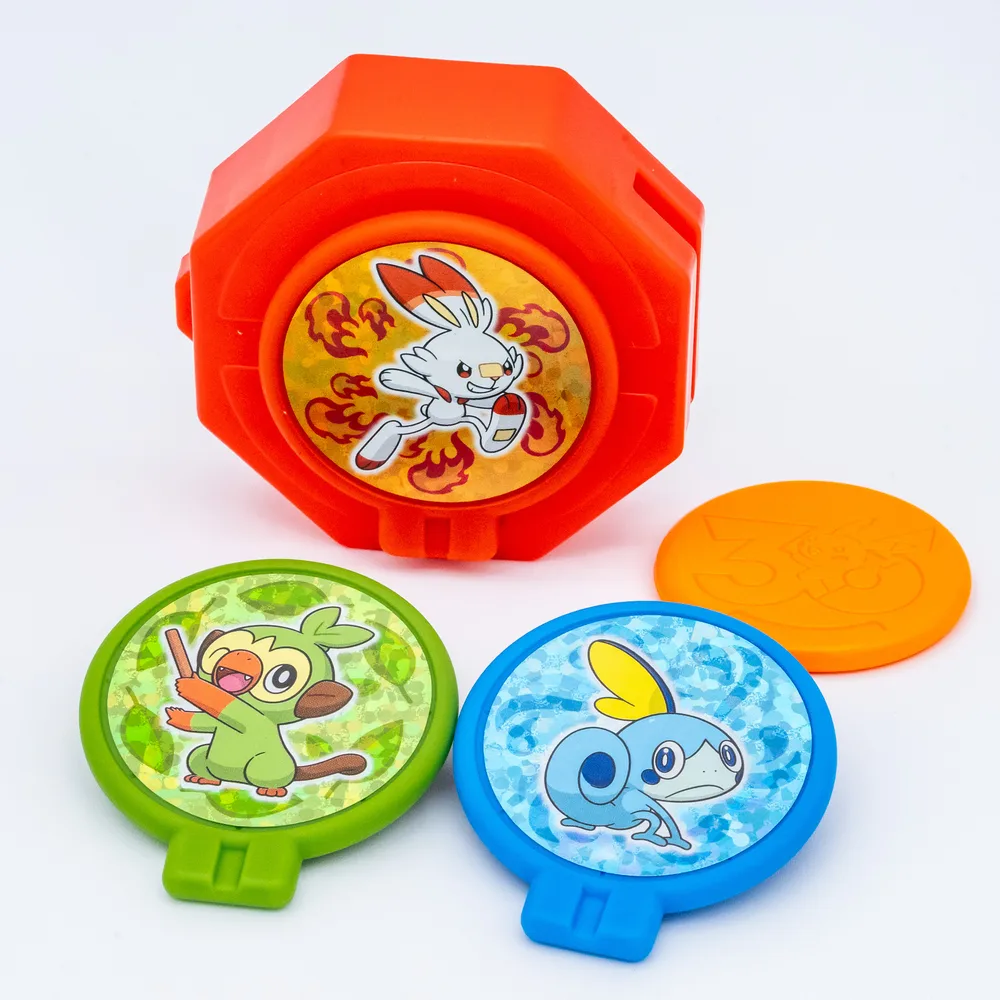 Close up of the orange disc stamped with the Pikachu 30th anniversary logo
