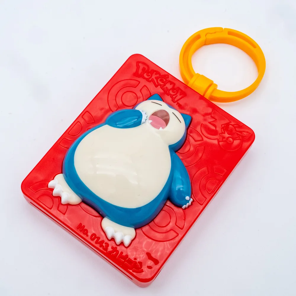 Front of the Snorlax Travel Name Tag showing the sculpted yawning Snorlax and the engraved No. 0143 Snorlax frame